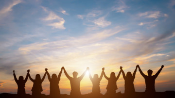 Silhouette of happy business team making high hands in sunset sky background for business teamwork concept