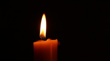 Closeup of a single candle burning.
